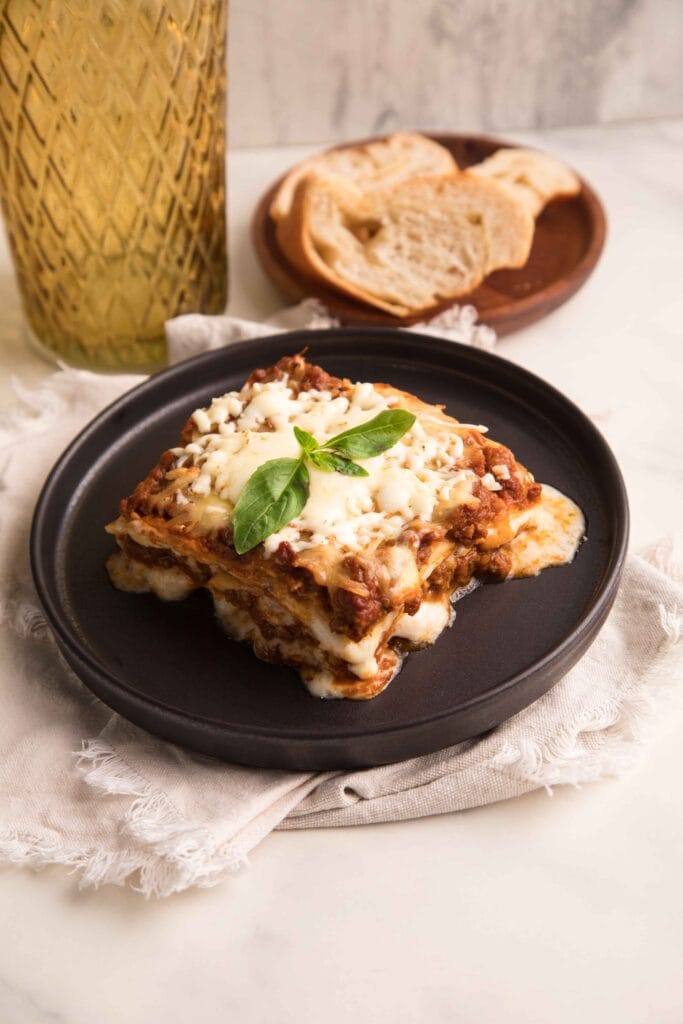 Cottage cheese lasagna served on a plate with a side of salad.