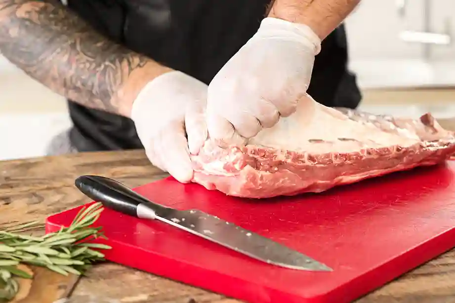 Removing the membrane from beef back ribs.