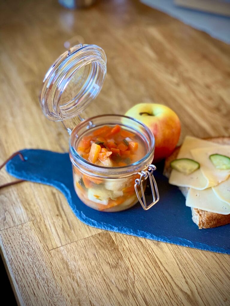 Homemade turkey soup in a glass container ready for storage.