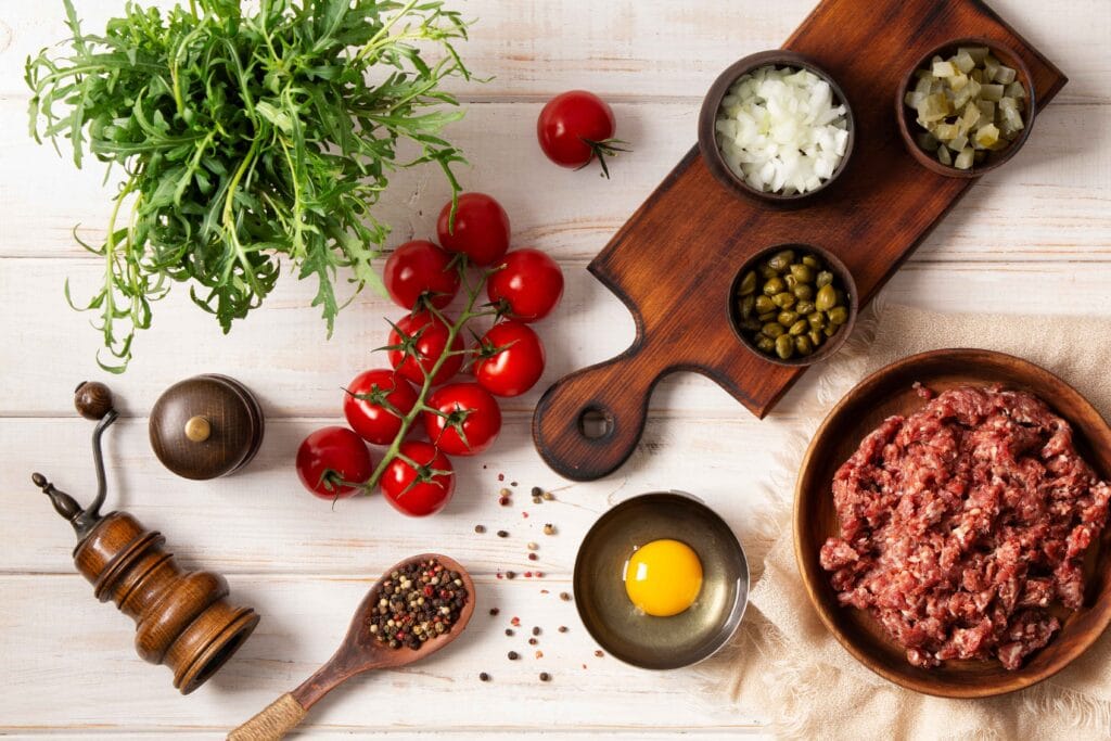 Ingredients laid out for making meatloaf, including breadcrumbs, eggs, and seasonings.