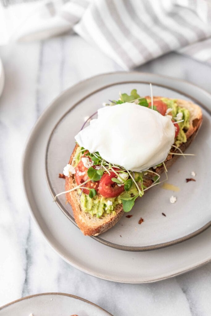 Cottage cheese on toast with avocado and tomatoes.