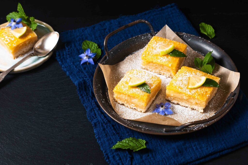 Lemon bars served on a white plate.