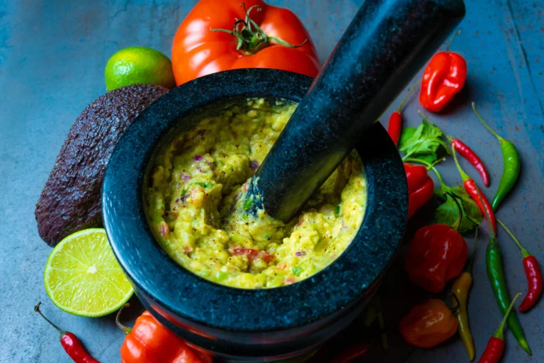 Traditional molcajete with fresh salsa and ingredients.