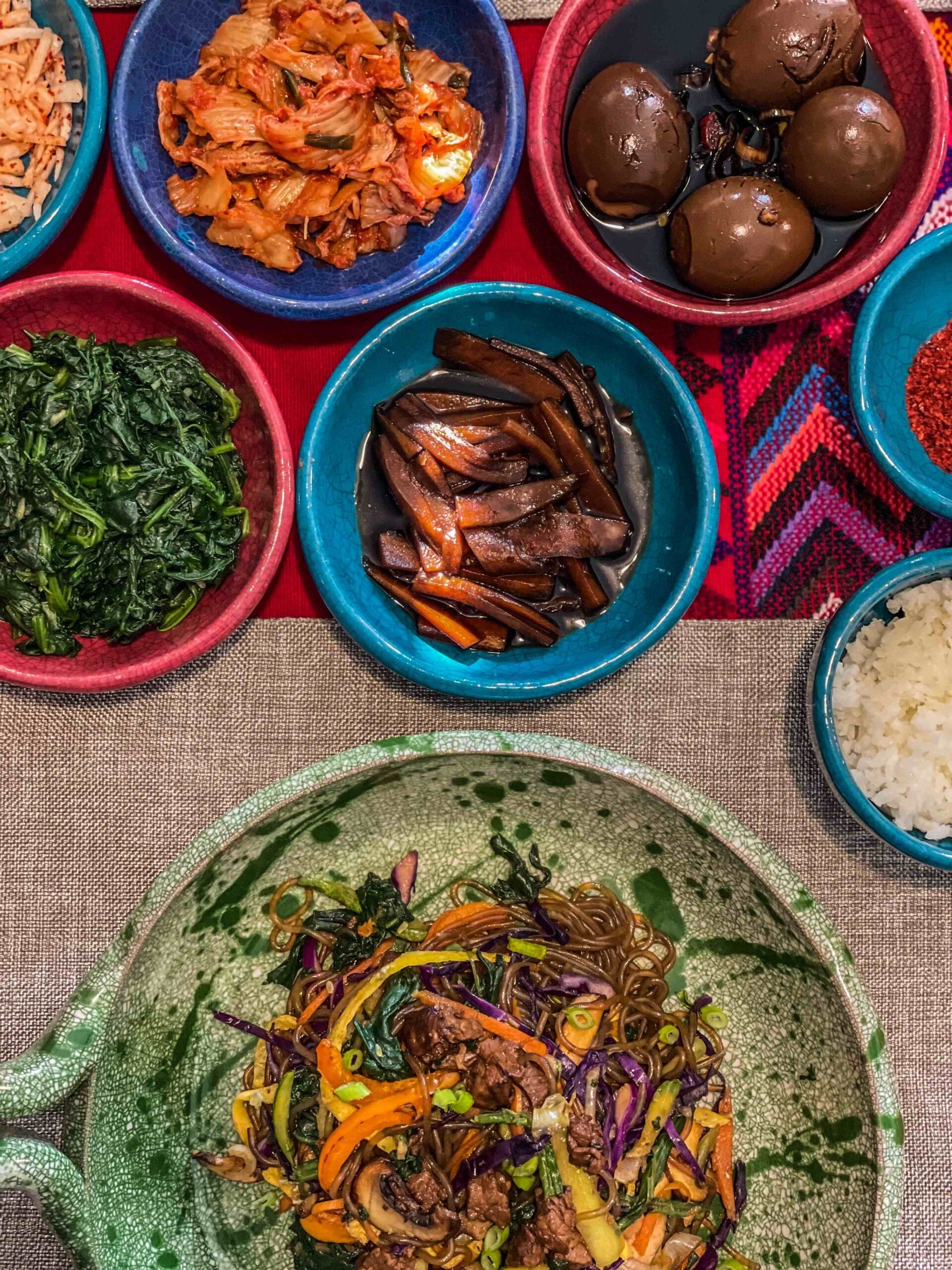 Korean side dishes served on a traditional wooden table