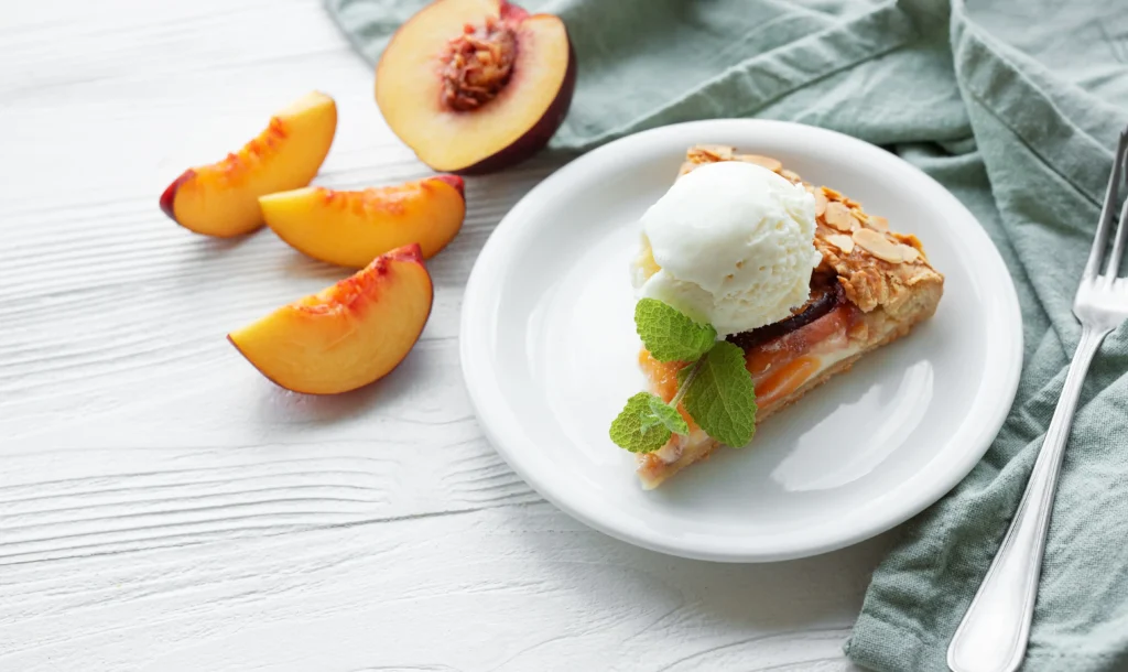 Peach cobbler served with vanilla ice cream