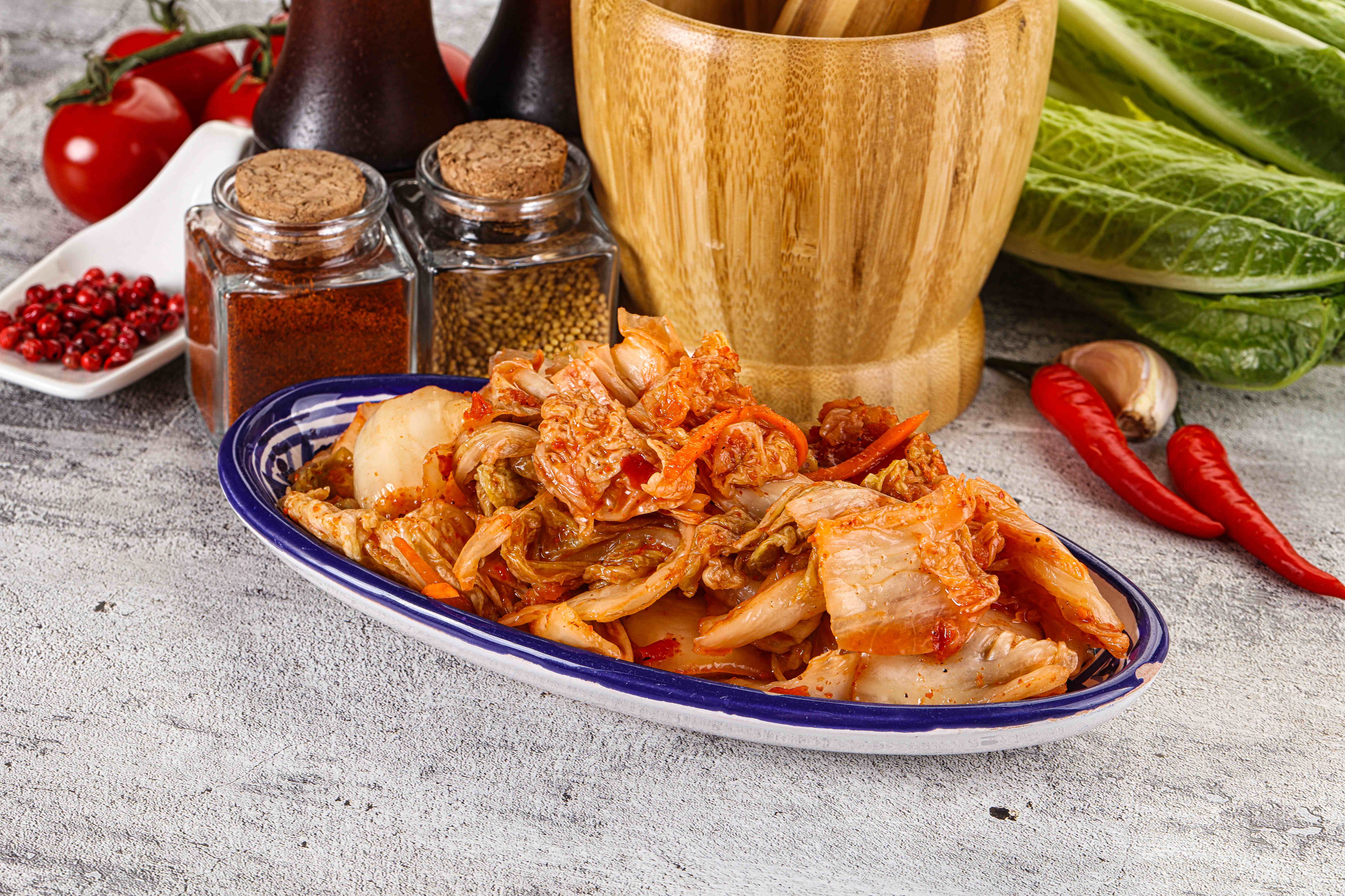 A bowl of freshly made kimchi with chopsticks beside it