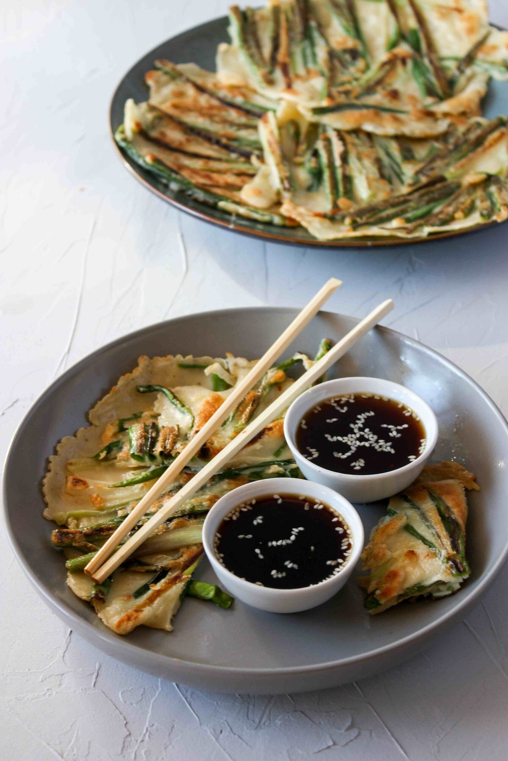 A plate of pajeon (scallion pancake) with dipping sauce